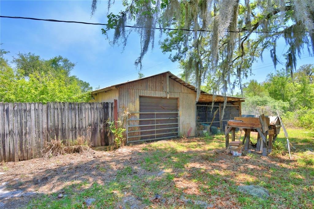 760 McClellan Road Frostproof, FL 33843 - Photo 31 of 72 a view of a house with a yard and wooden fence