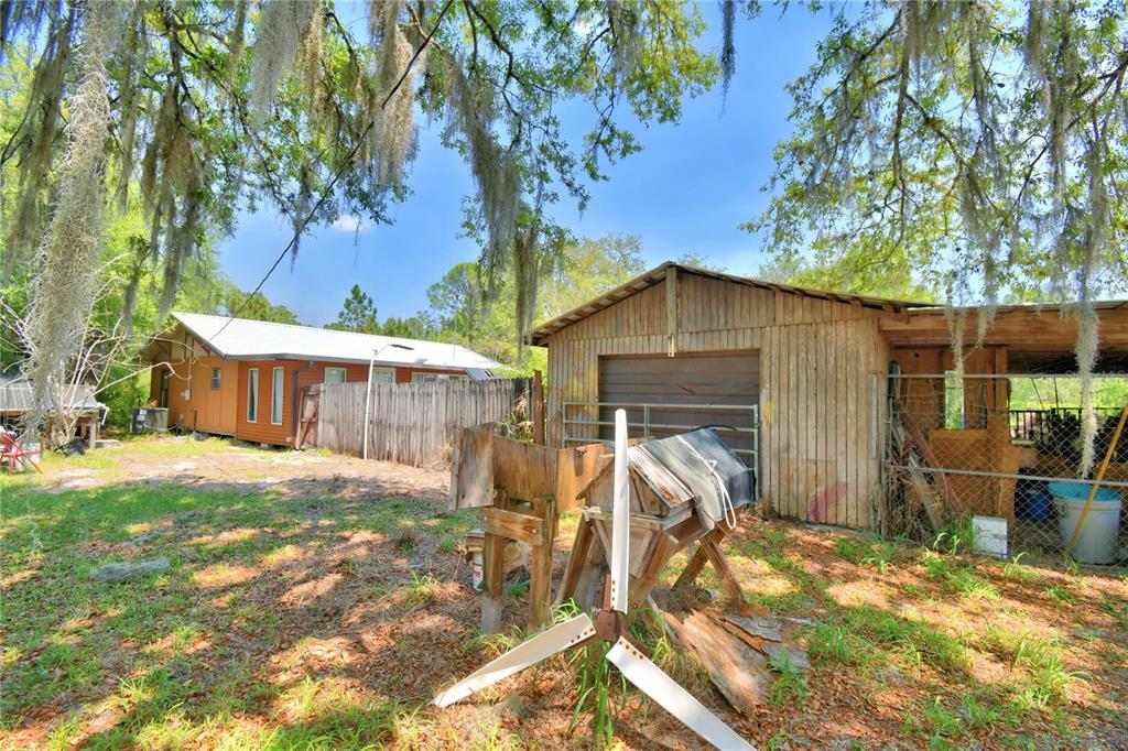 760 McClellan Road Frostproof, FL 33843 - Photo 40 of 72 a view of a house with backyard and sitting area