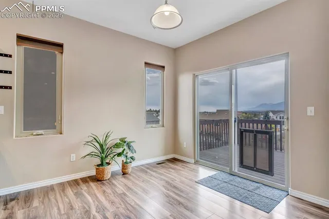 a view of livingroom with entryway and wooden floor