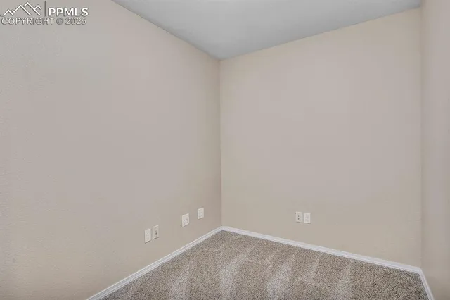 a view of a house with a wooden fence