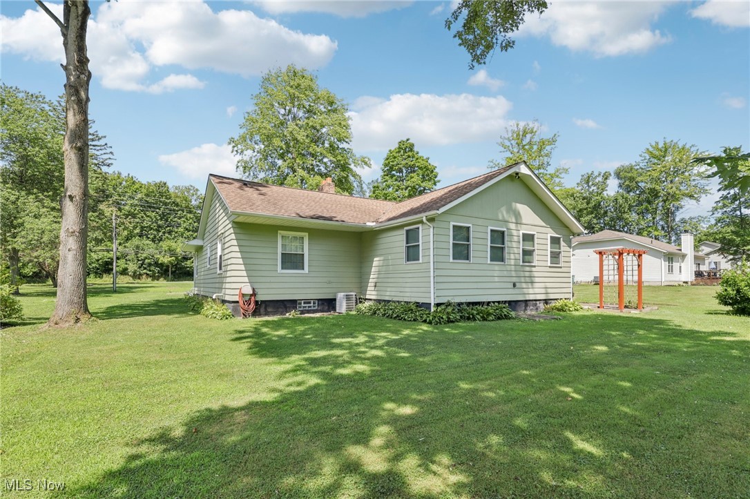 5097 Chillicothe Road Chagrin Falls, OH 44022 - Photo 39 of 45 Rear view of house with a chimney and a lawn