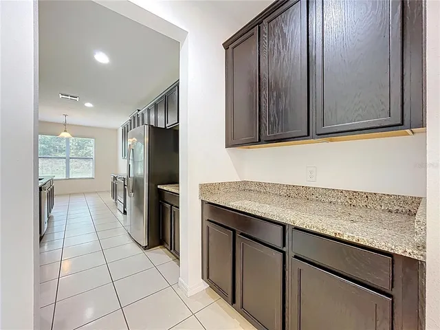 a large kitchen with cabinets stainless steel appliances and a counter top space