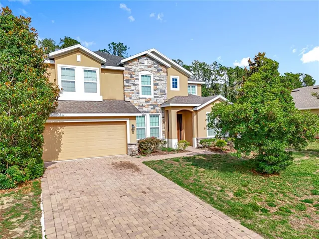 a front view of a house with a yard and garage