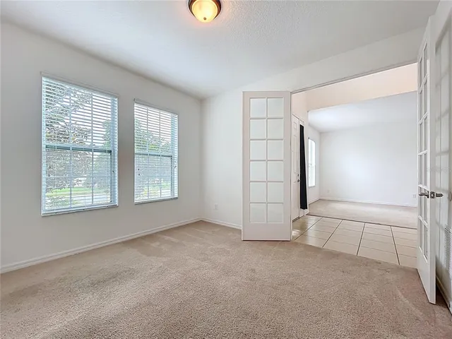 an empty room with windows and closet