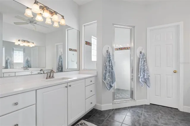a bathroom with a toilet sink vanity and mirror