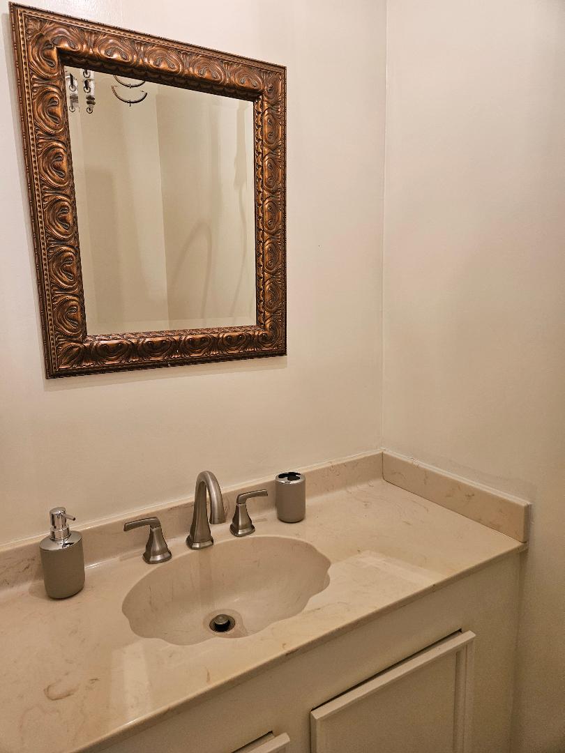 710 North Avenue C Elgin, TX 78621 - Photo 20 of 33 a bathroom with a sink and a mirror