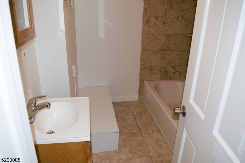 55 Highway 23, Unit 2 Hamburg, NJ 07419 - Photo 5 of 11 a bathroom with a tub a sink and a shower curtain