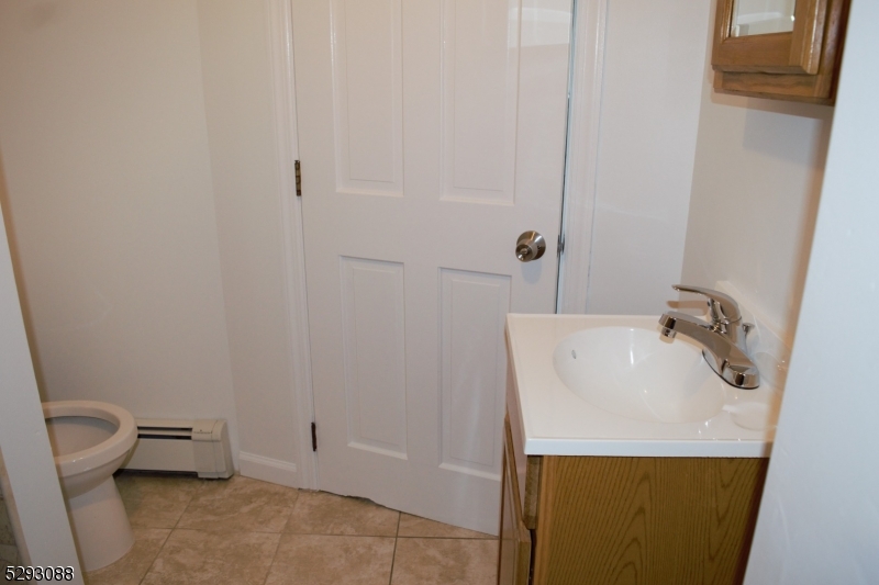 55 Highway 23, Unit 2 Hamburg, NJ 07419 - Photo 6 of 11 a bathroom with a sink a toilet and a mirror