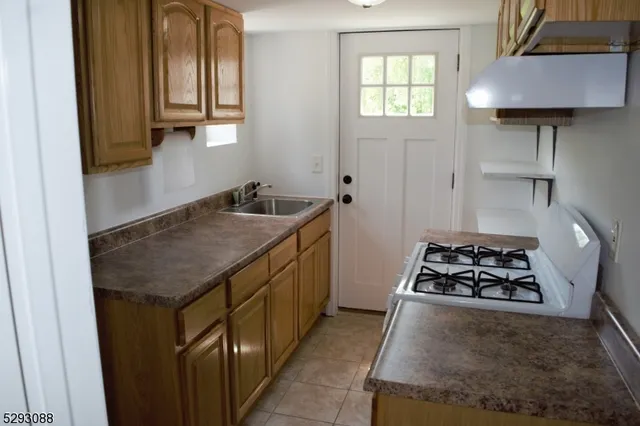 a kitchen that has a sink and a stove