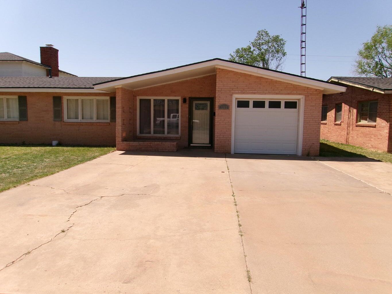 1201 Borger Plainview, TX 79072 - Photo 2 of 22 a front view of a house with a yard