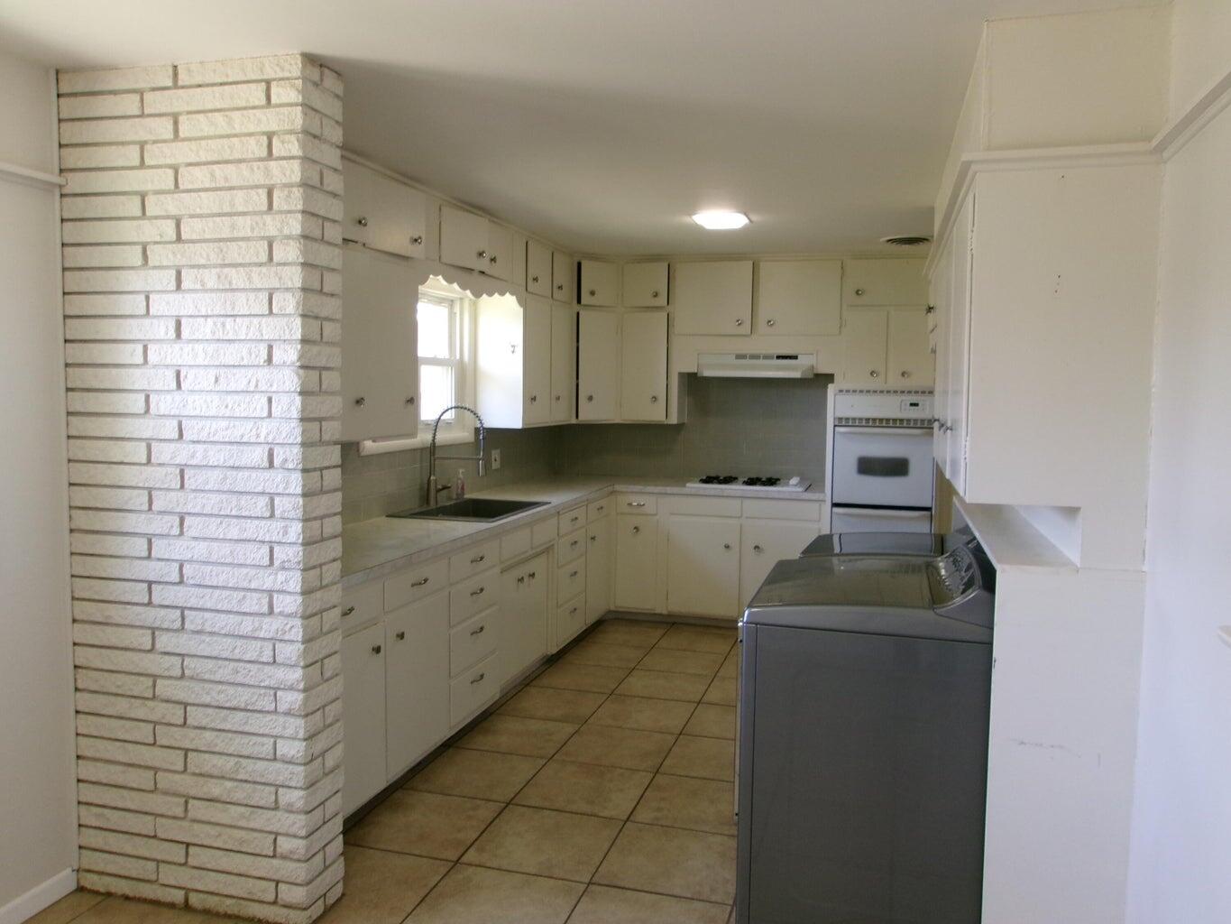 1201 Borger Plainview, TX 79072 - Photo 5 of 22 a kitchen with a cabinets and a stove top oven