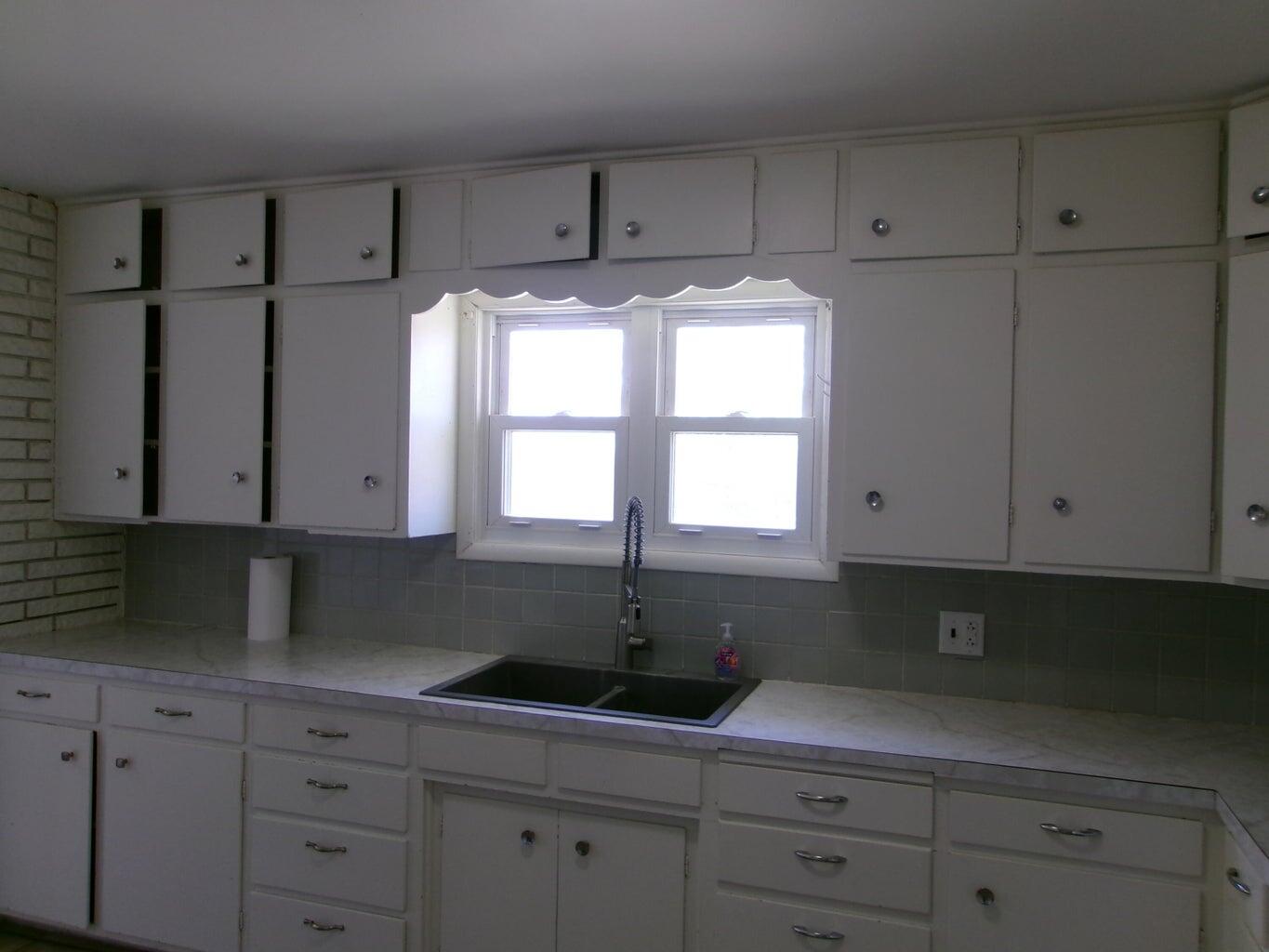 1201 Borger Plainview, TX 79072 - Photo 8 of 22 a kitchen with appliances cabinets and a window
