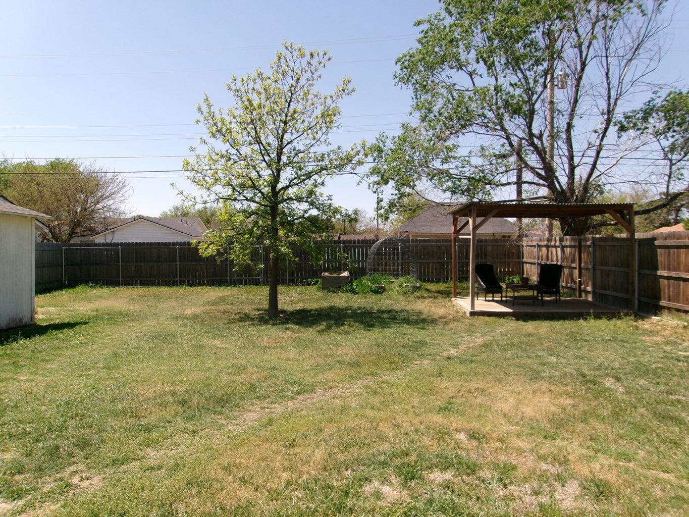 1201 Borger Plainview, TX 79072 - Photo 9 of 22 a view of a house with backyard and a tree