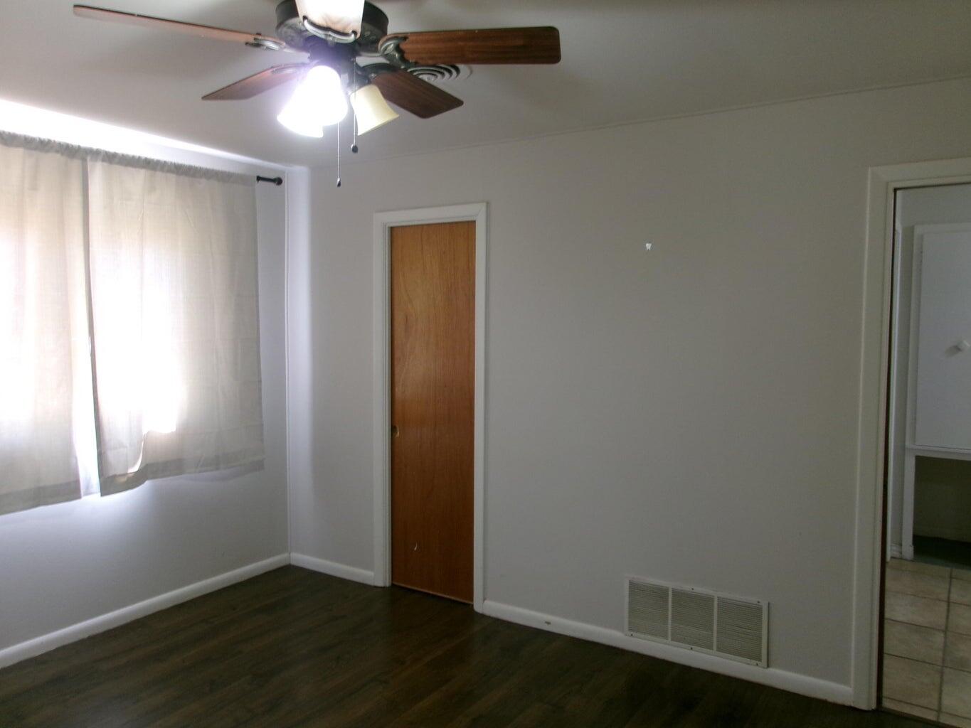 1201 Borger Plainview, TX 79072 - Photo 10 of 22 a view of an empty room with wooden floor and a window