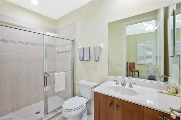 a bathroom with a sink toilet vanity and shower
