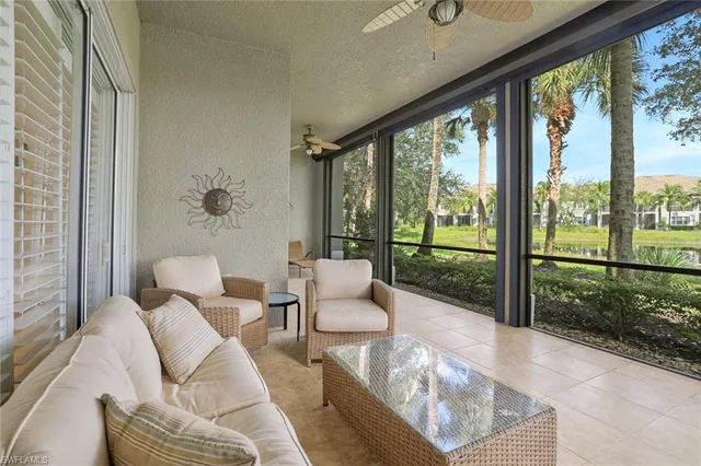 a living room with furniture and a floor to ceiling window