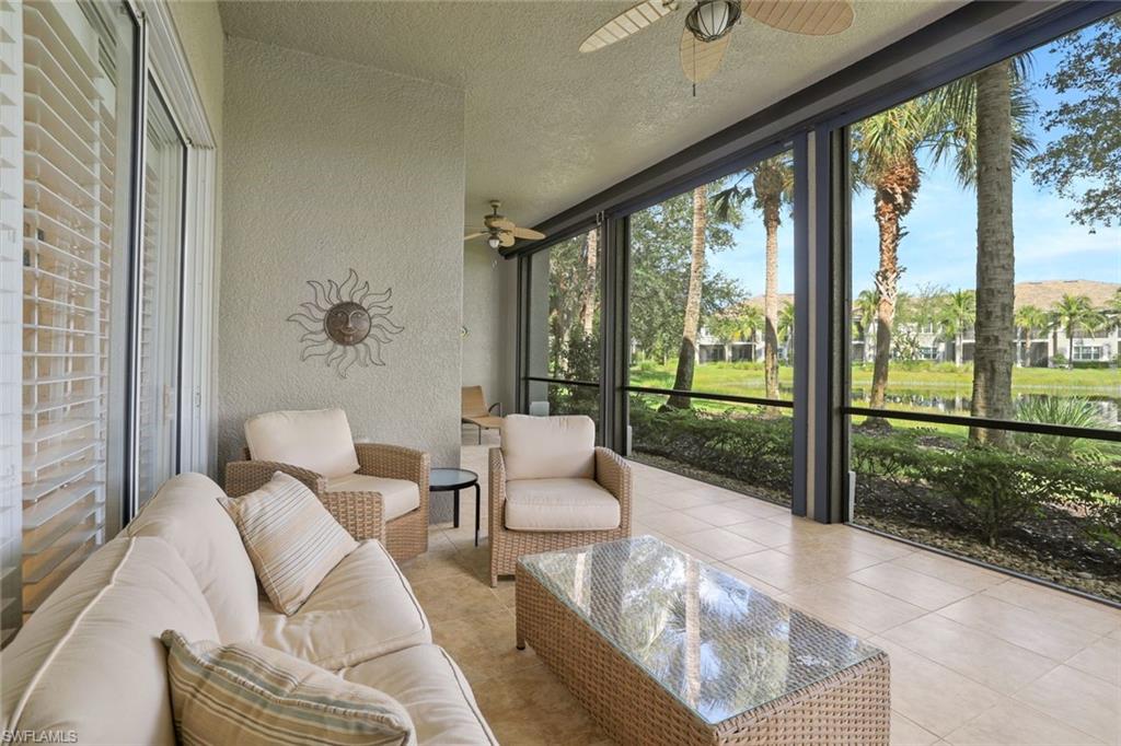 9209 Museo Circle, Unit 102 Naples, FL 34114 - Photo 17 of 18 a living room with furniture and a floor to ceiling window