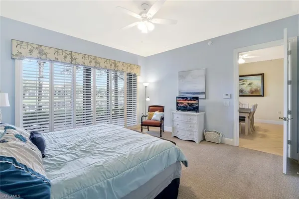 a bedroom with a large bed and a chandelier
