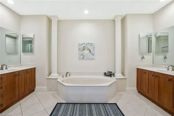 a spacious bathroom with a bathtub and a sink
