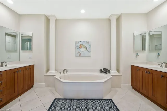 a spacious bathroom with a bathtub and a sink