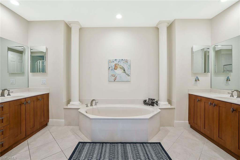 9209 Museo Circle, Unit 102 Naples, FL 34114 - Photo 10 of 18 a spacious bathroom with a bathtub and a sink