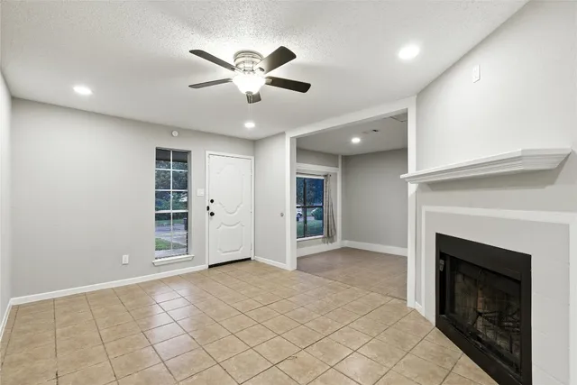 a view of an empty room with a fireplace