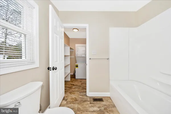 a bathroom with a bathtub and toilet