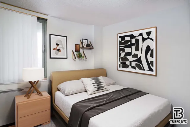 a bedroom with a bed and wall painting