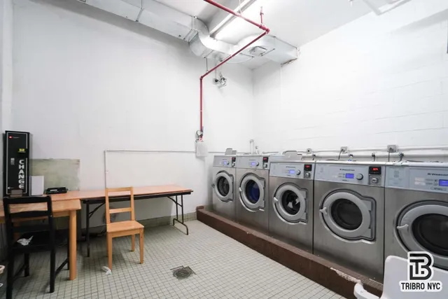 a utility room with dryer washer and stair