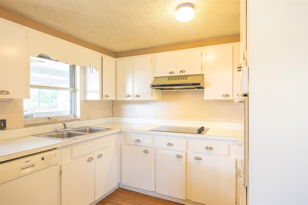 925 Angies Crossing Tool, TX 75143 - Photo 14 of 25 a kitchen with granite countertop a sink and a window