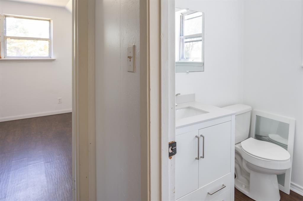 925 Angies Crossing Tool, TX 75143 - Photo 21 of 25 a white toilet sitting next to a bathroom sink