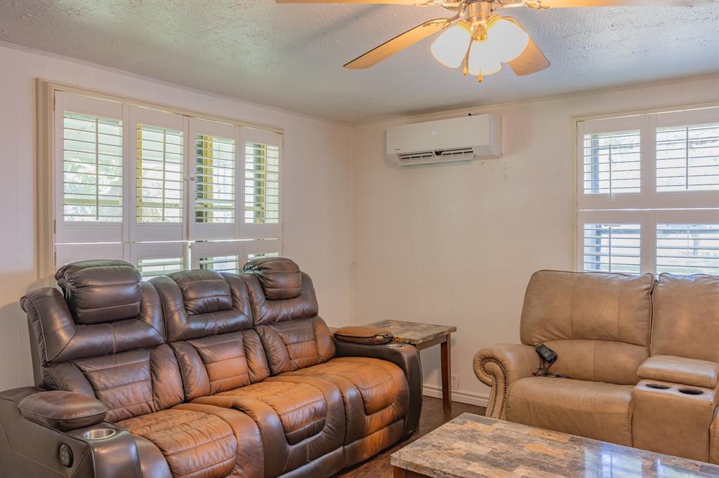 925 Angies Crossing Tool, TX 75143 - Photo 10 of 25 a blue couch sitting in a living room next to a window