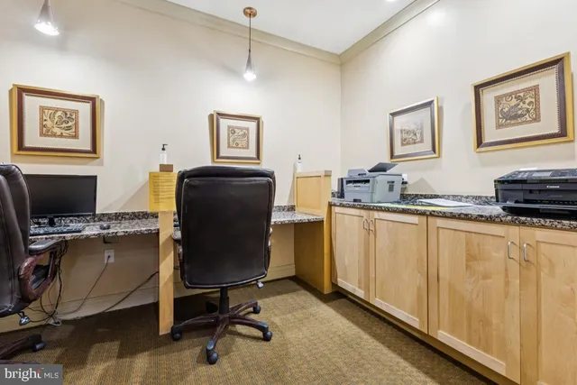 a kitchen with kitchen island granite countertop a sink a counter top space appliances and cabinets