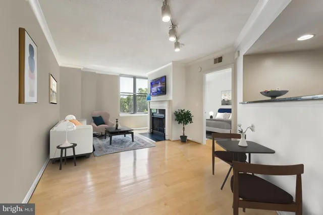 a view of a big room with wooden floor and a kitchen