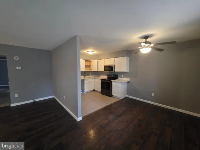 a view of a kitchen with a sink a kitchen a refrigerator and a stove top oven