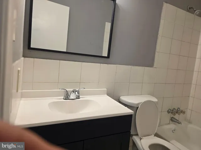 a bathroom with a sink toilet and mirror