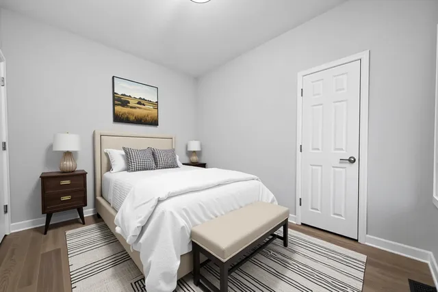 a bedroom with a bed and a painting on the wall