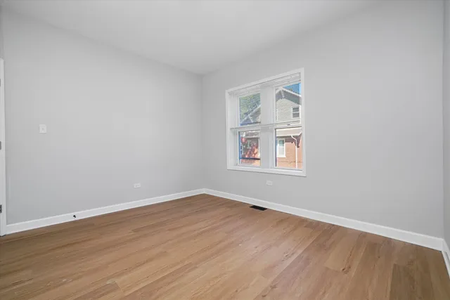 a view of a room with wooden floor and windows