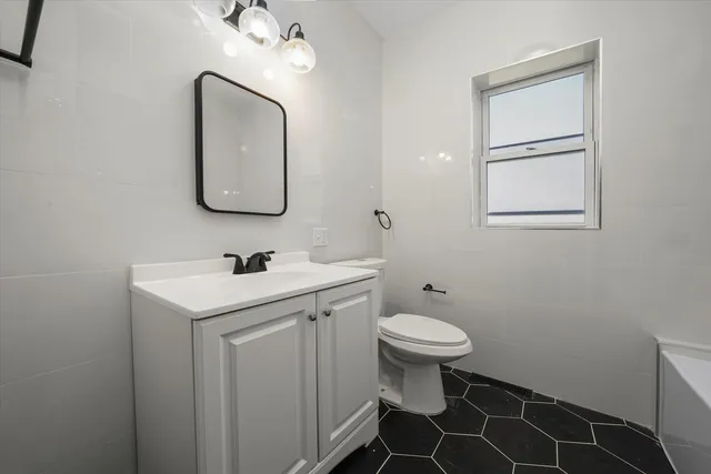 a bathroom with a sink toilet and vanity