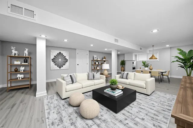 a living room with furniture and wooden floor