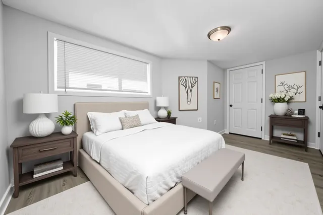 a bedroom with a bed and window