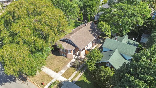 an aerial view of a house with yard