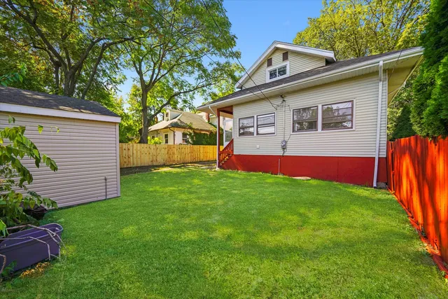 a view of backyard with deck and outdoor seating