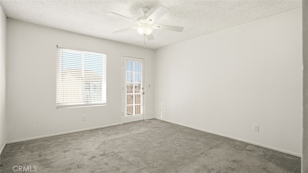 833 Cinnamon Lane, Unit 4 Duarte, CA 91010 - Photo 21 of 34 an empty room with windows and fan