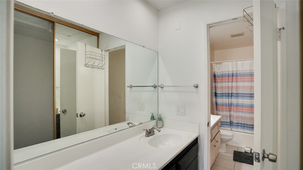 833 Cinnamon Lane, Unit 4 Duarte, CA 91010 - Photo 23 of 34 a bathroom with a granite countertop sink a mirror and shower