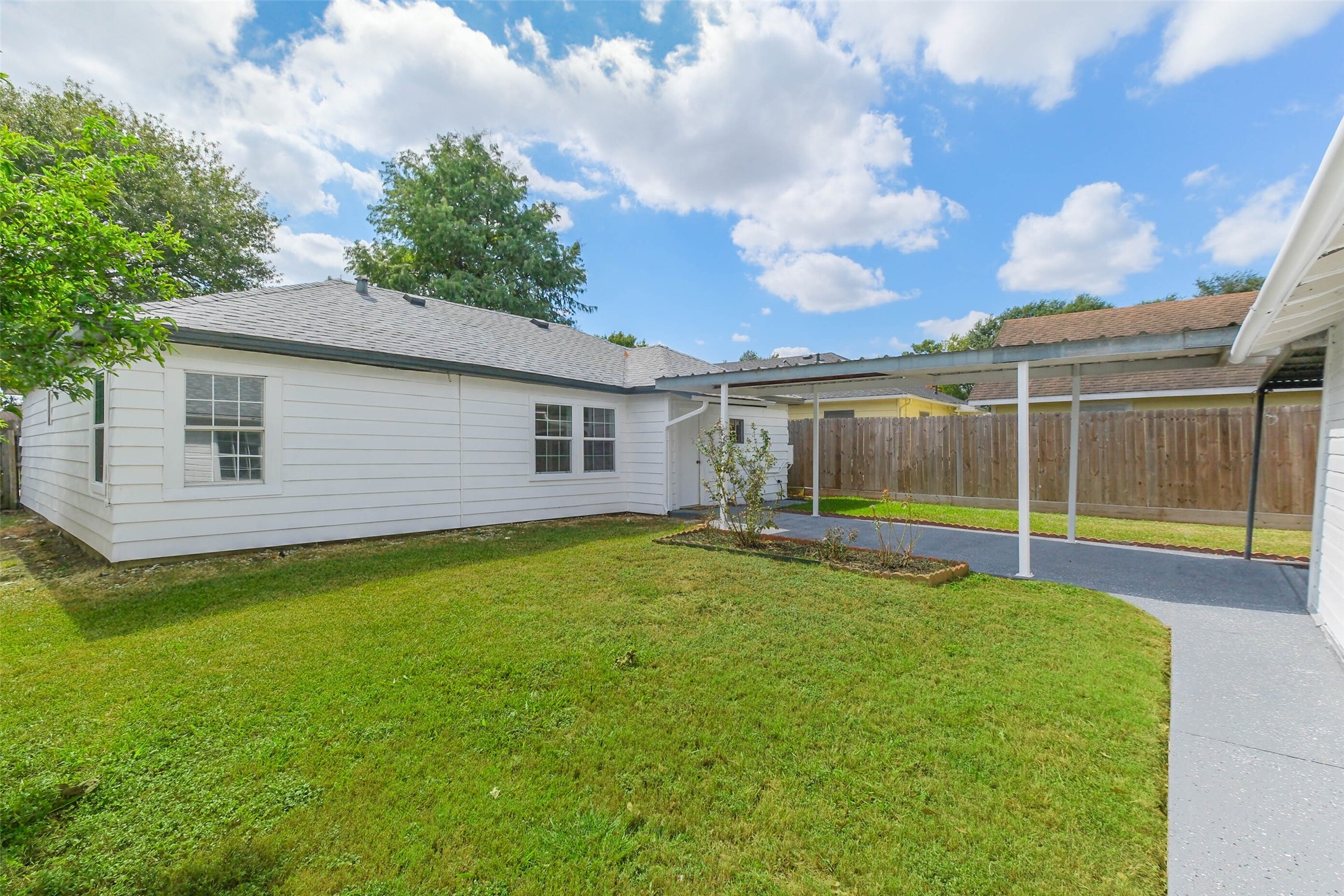 7543 Greenstone Street Houston, TX 77087 - Photo 18 of 24 a view of a backyard with a garden and plants
