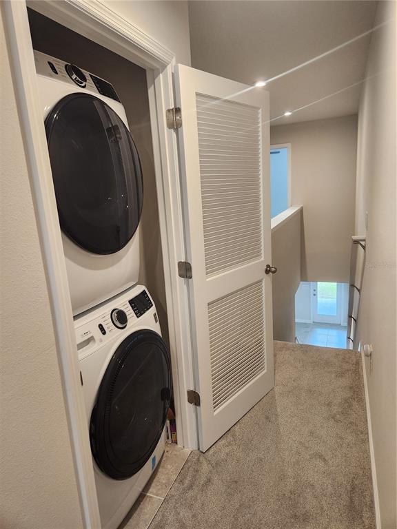 12003 Grizzly Lane New Port Richey, FL 34654 - Photo 35 of 43 a view of a storage and utility room with washer and dryer