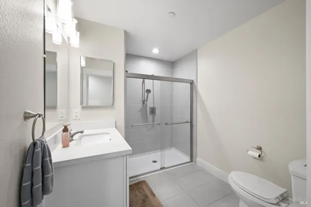 a bathroom with a glass shower door