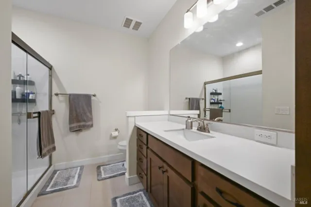 a bathroom with a shower and mirror