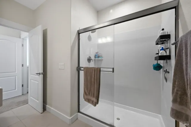 a bathroom with a double vanity sink and mirror with shower